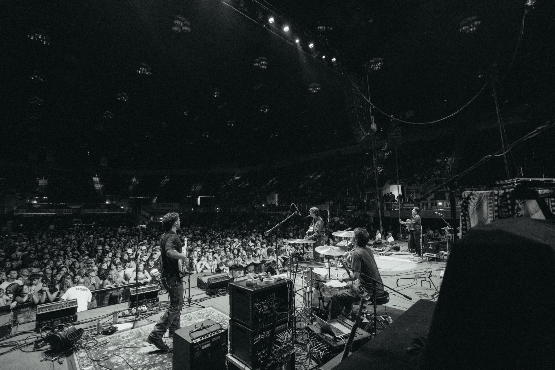 A view from the stage of Phil Kane performing with his band in front of a packed crowd