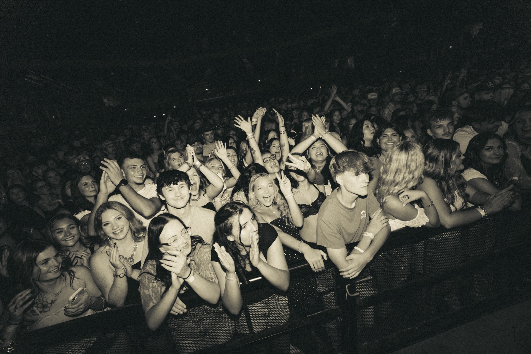 Fans cheering at the front of the crowd during a Phil Kane show